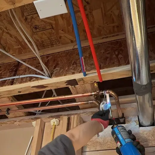 Exposed drain piping and cleanout access during plumbing rough-in work for Plumbing Service Areas in the West Valley