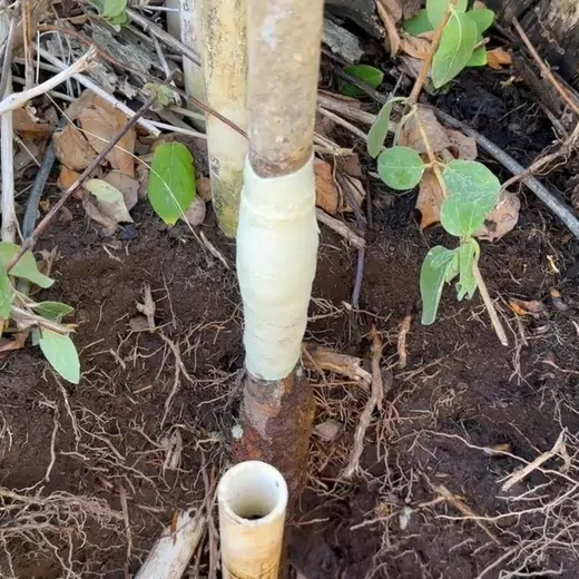 Exposed water line connection being repaired near an outdoor or utility access point for Plumbing Services in Goodyear showing exposed water line connection being repaired near outdoor utility access point garage