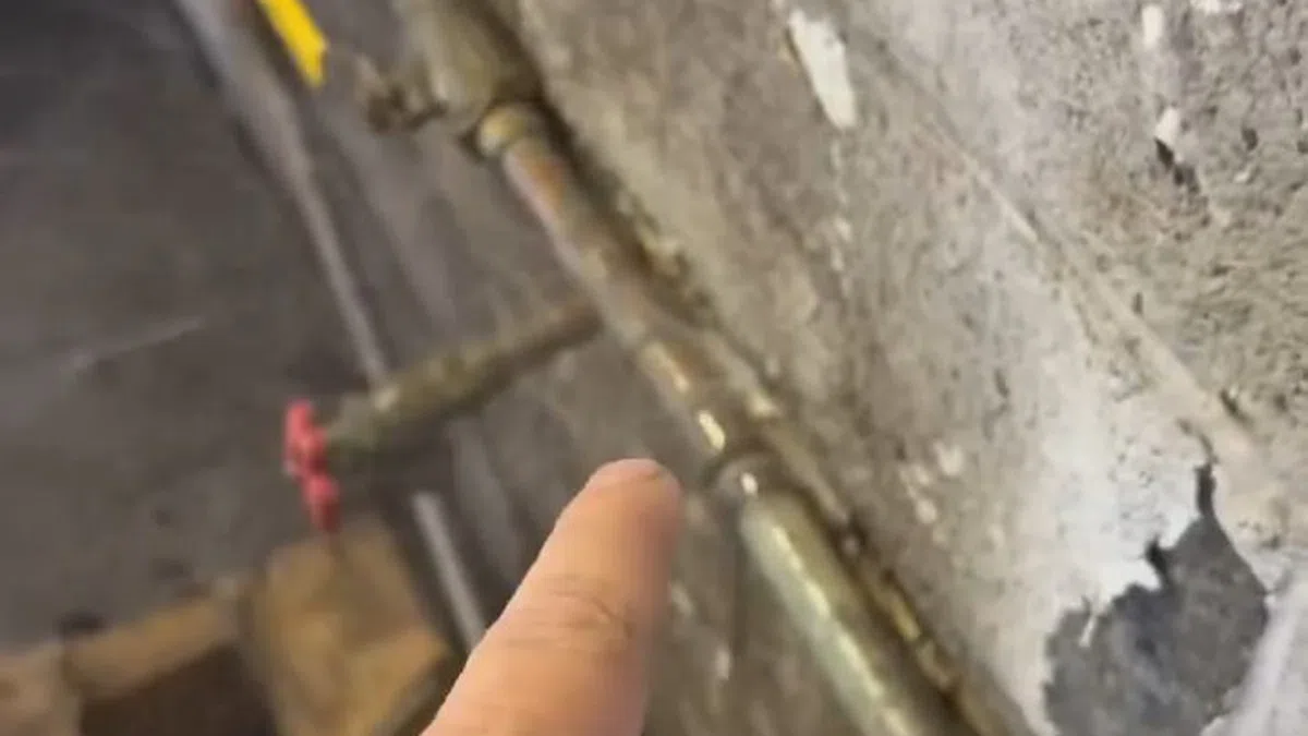 Exposed water line connection being repaired near an outdoor or utility access point for Plumbing Services in West Phoenix,