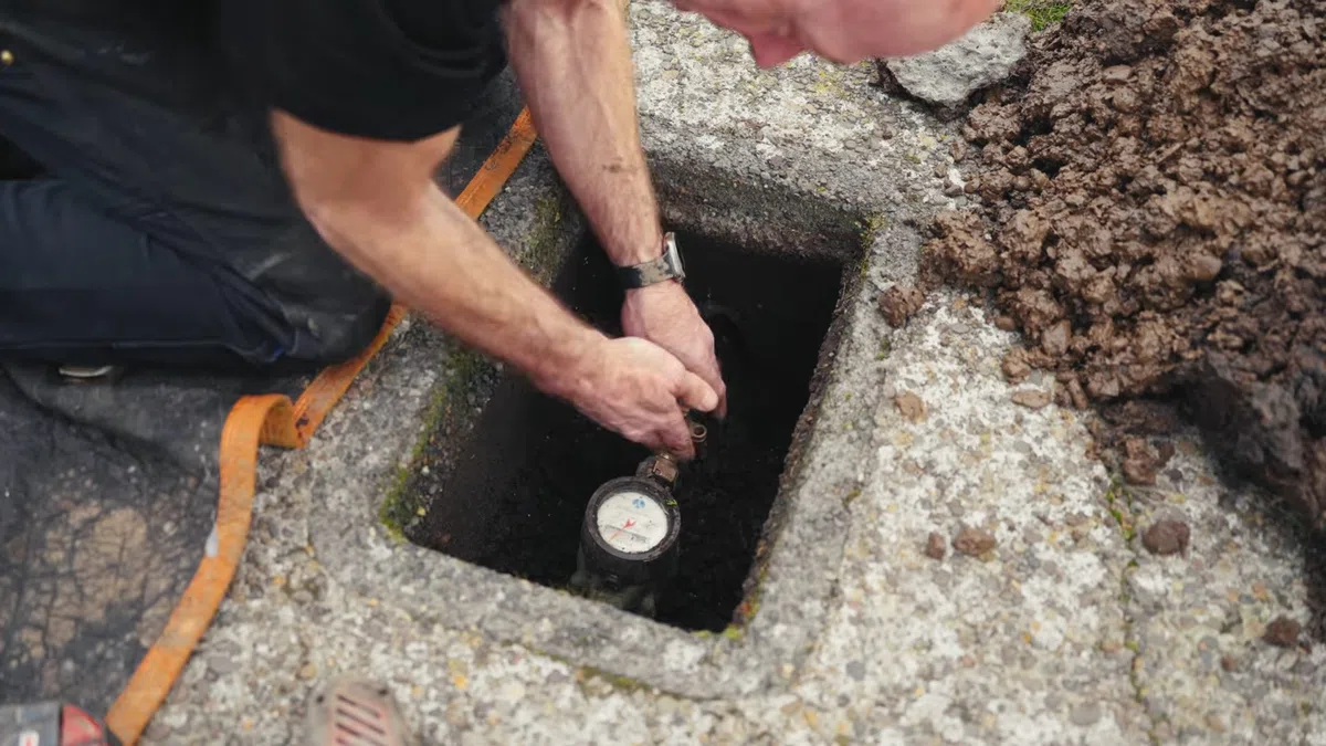 Exposed water line connection being repaired near an outdoor or utility access point for Burst Pipe Repair in Goodyear