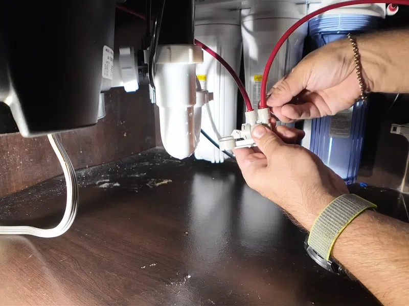 Garbage disposal and dishwasher drain connections below a kitchen sink for Garbage Disposal Repair & Installation in Goodyear showing garbage disposal dishwasher drain connections below kitchen sink repair installation body