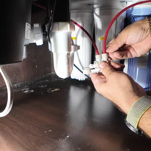 Garbage disposal and dishwasher drain connections below a kitchen sink for Plumbing Services in Goodyear