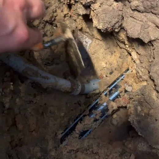 Opened slab area and leak detection equipment used to locate a hidden pipe leak for Plumbing Services in Goodyear