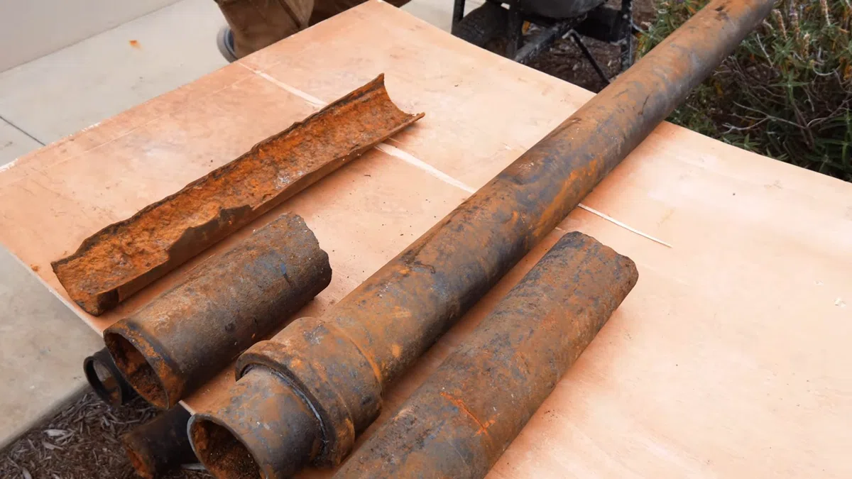 Rusted cast iron pipe sections showing corrosion and interior buildup for Plumbing Services in Surprise,