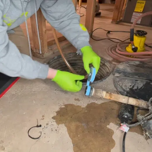 Sump pump basin and discharge piping during installation or service for Plumbing Services in Goodyear showing sump pump basin discharge piping installation thumbnail closeup