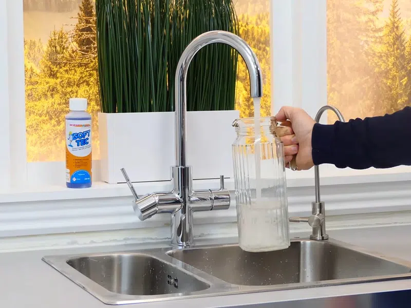 Whole-home water softener with control valve, brine tank, and plumbing connections for Plumbing Services in Glendale,