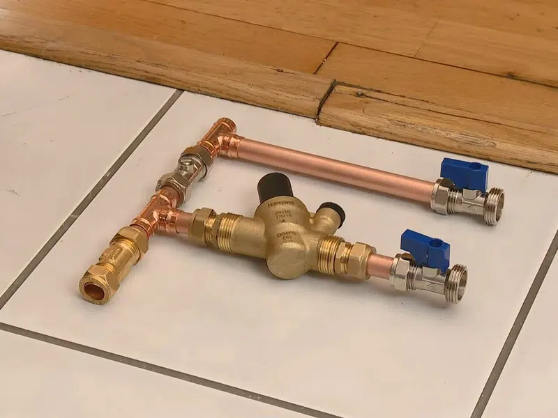 Whole-home water softener with control valve, brine tank, and plumbing connections for Plumbing Services in West Phoenix,
