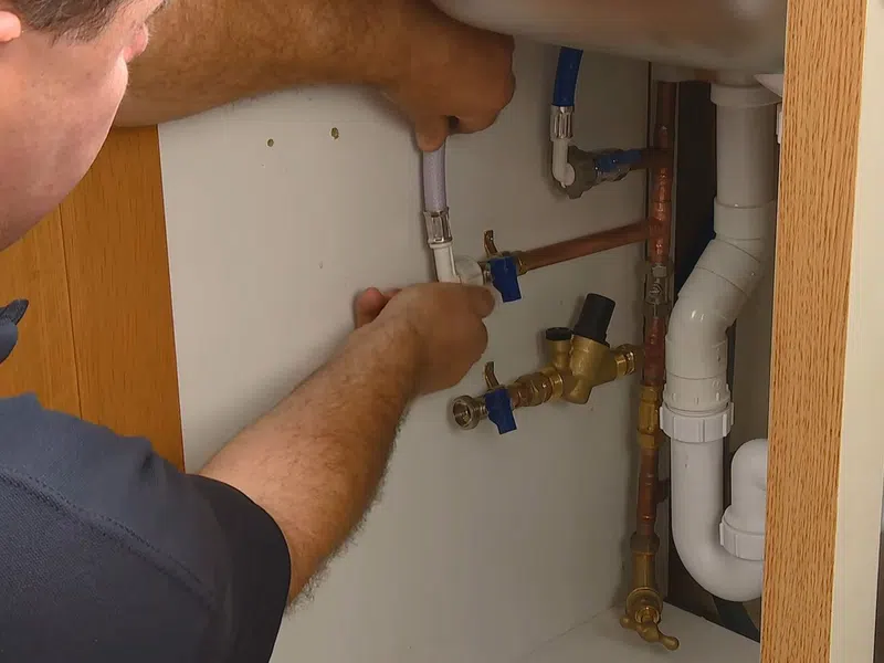 Whole-home water softener with control valve, brine tank, and plumbing connections for Plumbing Services in Surprise,