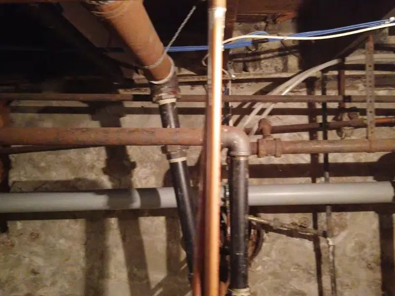 Plumber working on residential plumbing components for Plumbing Services in Glendale,