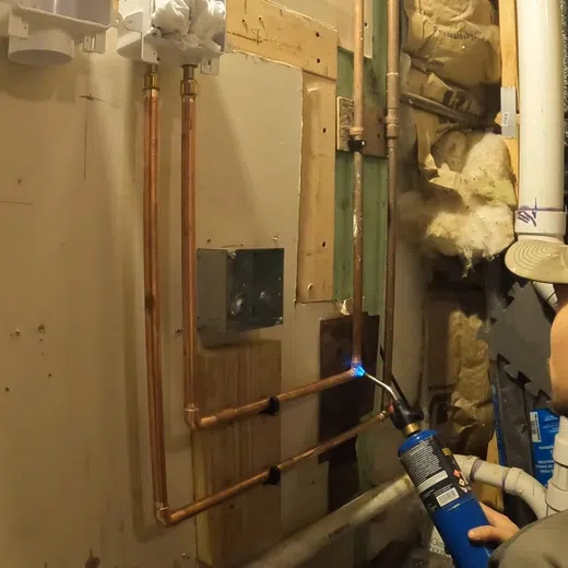 Plumber working on residential plumbing components for Plumbing Service Areas in the West Valley showing working residential components thumbnail install